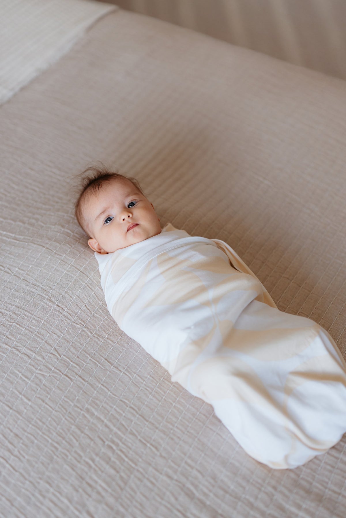 In-home consult shoot: swaddled baby on bed