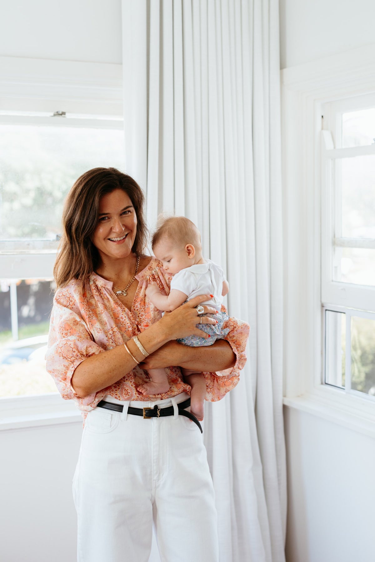 In-home consult shoot: mum holding baby window