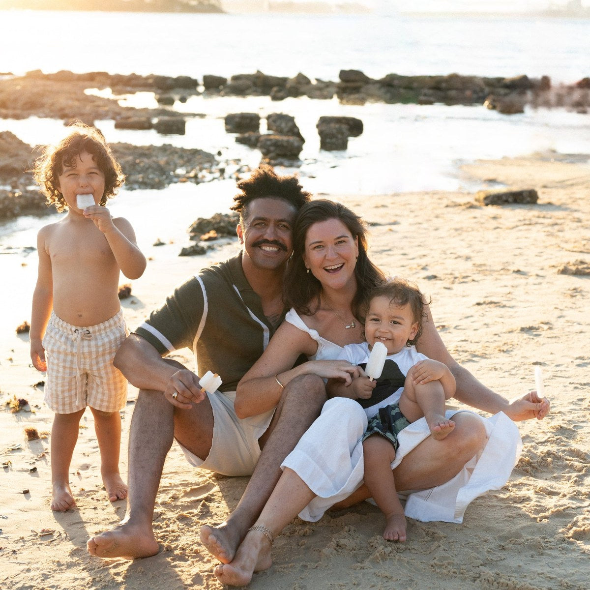 Family on the beach at sunset